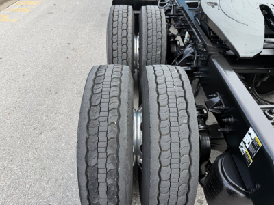 Truck rear dual-axle configuration showing tires and suspension undercarriage of a Peterbilt 579 chassis.