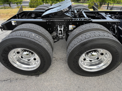 Peterbilt 579 truck chassis showing dual rear axles with Goodyear tires and chrome wheels; visible frame rails and fifth wheel area.