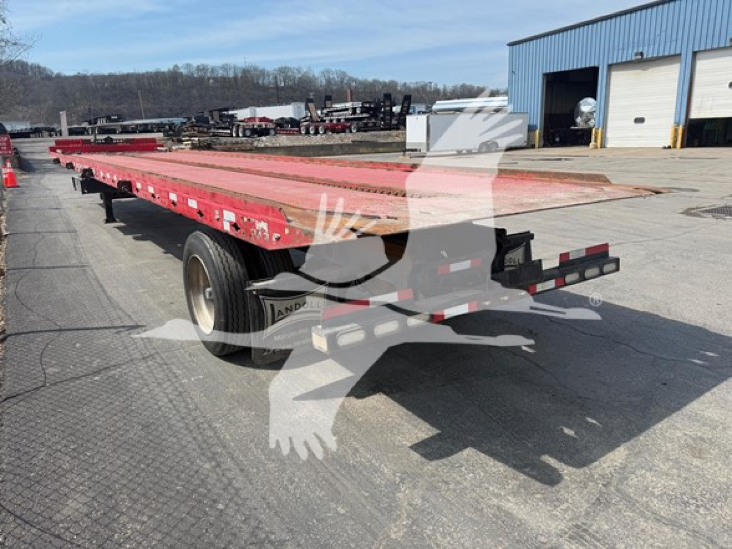 Trailer showing a red Landoll 343B equipment trailer with dual axle and flatbed, VIN plate not clearly legible, stock number 7483 visible in listing context