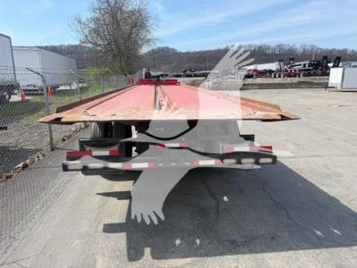 Flatbed trailer viewed from rear with red deck and black undercarriage. No visible text readable on components.