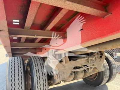 Trailer undercarriage showing dual rear axles, suspension, and underside of a red Landoll 343B trailer.