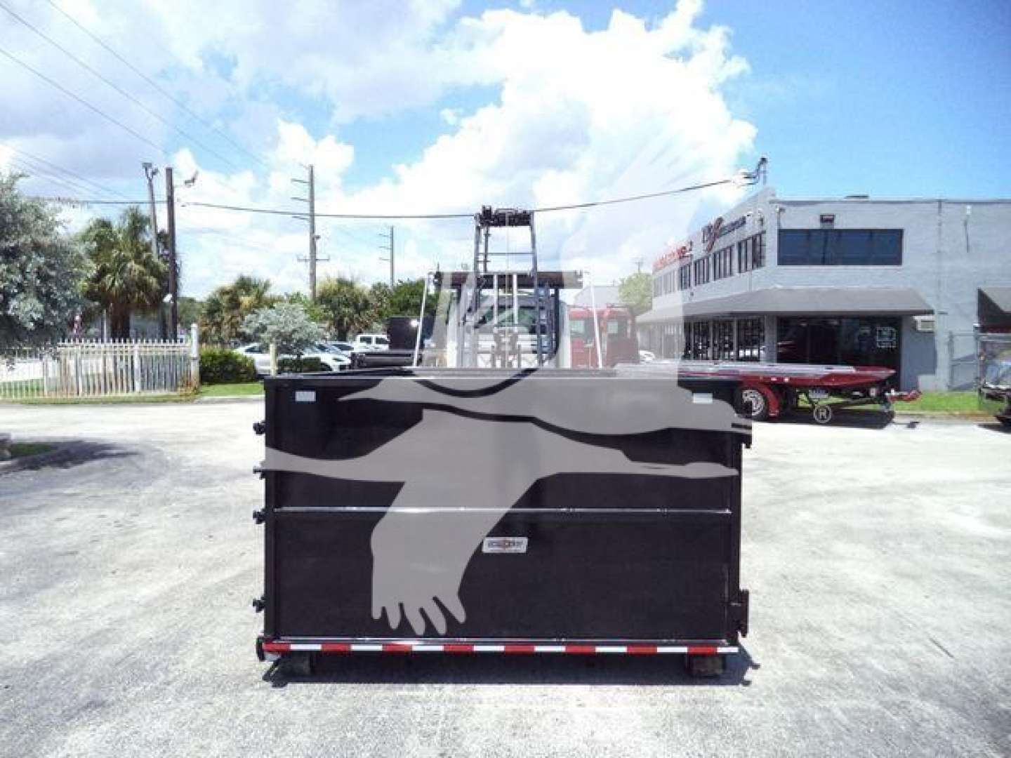 Truck bed of a 2020 International MV rolloff showing a large graphic on the tailgate and a hydraulic setup in the background.