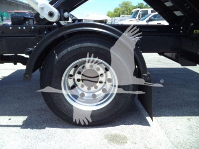 Truck wheel and fender detail on a 2020 International MV roll-off chassis showing steel wheel and tire with surrounding components.