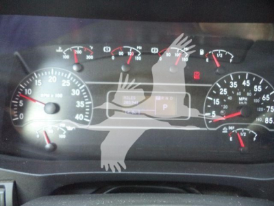 Cab dashboard of a 2020 International MV roll-off truck showing speedometer, tachometer, and warning lights with a central display and gear indicator.