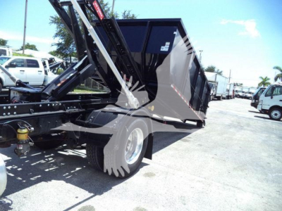 Truck bed dump body showing side view with hydraulic lift and wheel, 2020 International MV dump truck.