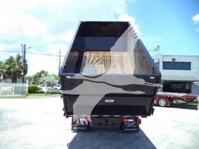 Truck rear view of a 2020 International MV roll-off truck showing dump bed and hitch with taillights and supporting wheels.