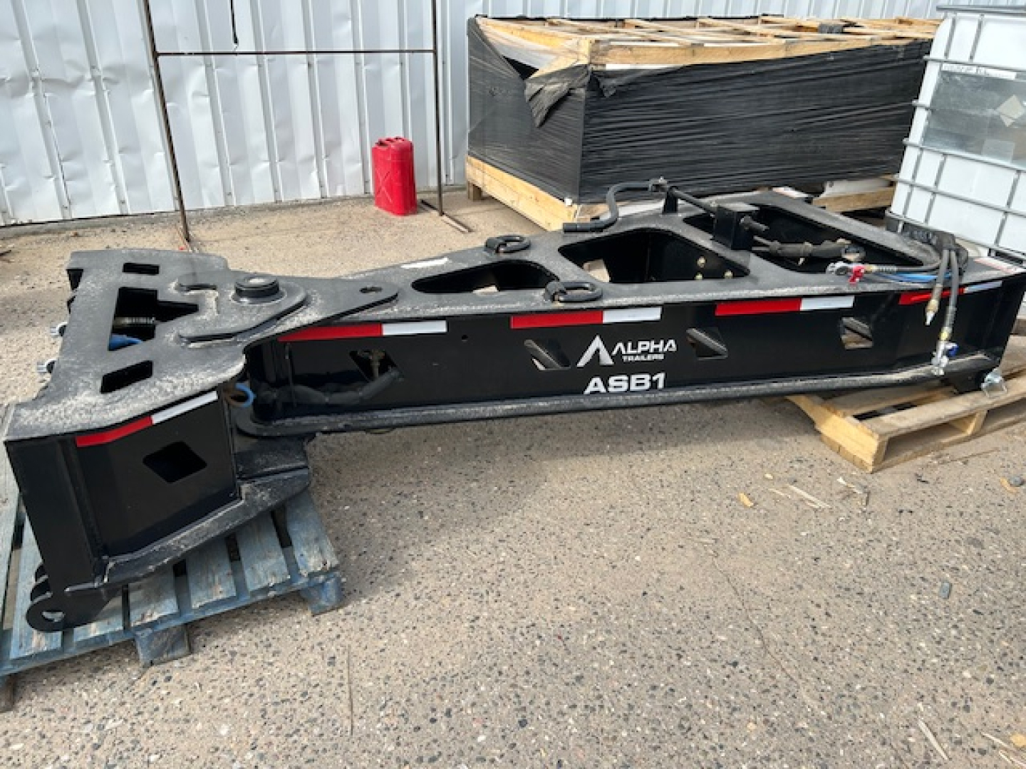 ASB1 55-ton spreader bar trailer side profile showing Alpha label and model ASB1 with structural rails on a lowboy frame.