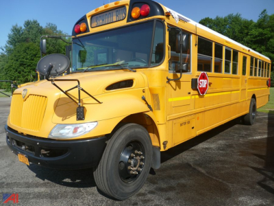 School bus front and side view with stop sign extended, yellow IC Corporation CE 3000 bus, front grille and wheels visible.