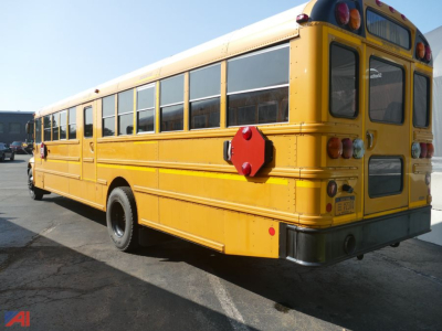 Yellow IC Corporation CE 3000 school bus rear view showing red emergency exit hatch and rear window with taillights.