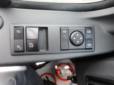 Cab and chassis interior panel showing window controls and joystick-style side mirror adjustment pad on Freightliner M2 106.