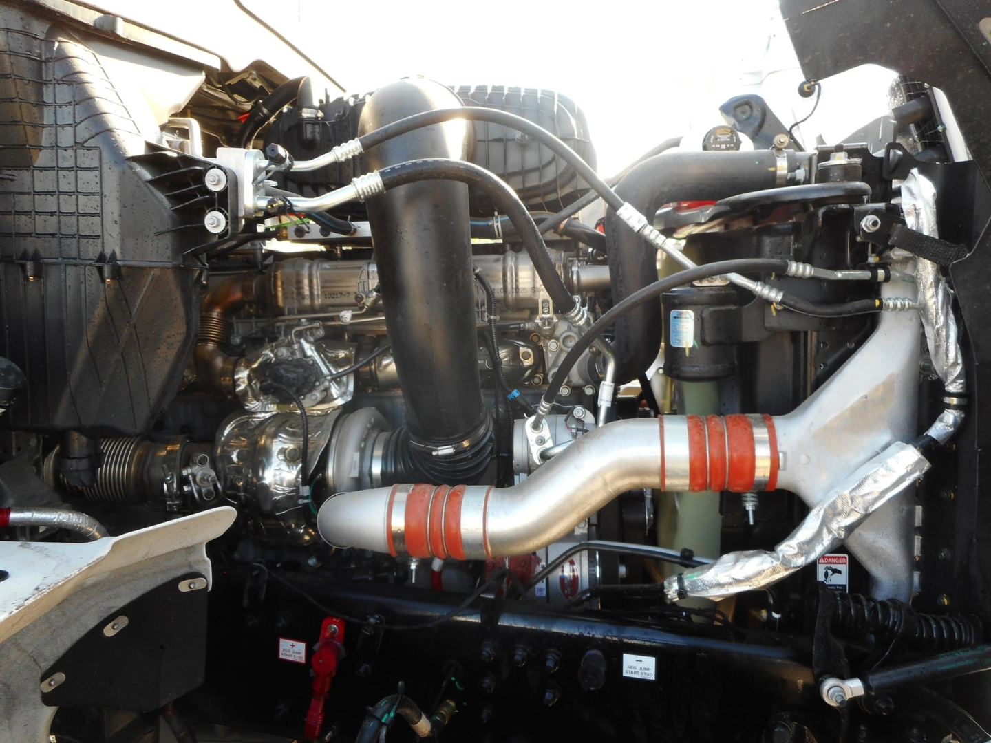 Western Star 49X engine bay showing turbocharged diesel engine with large intake pipe and coolant reservoir