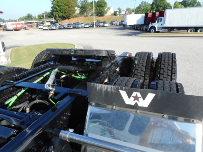 Western Star 49X truck chassis and cab area with blue frame, green hydraulic lines, and dual rear axles; 'W' logo on the side.