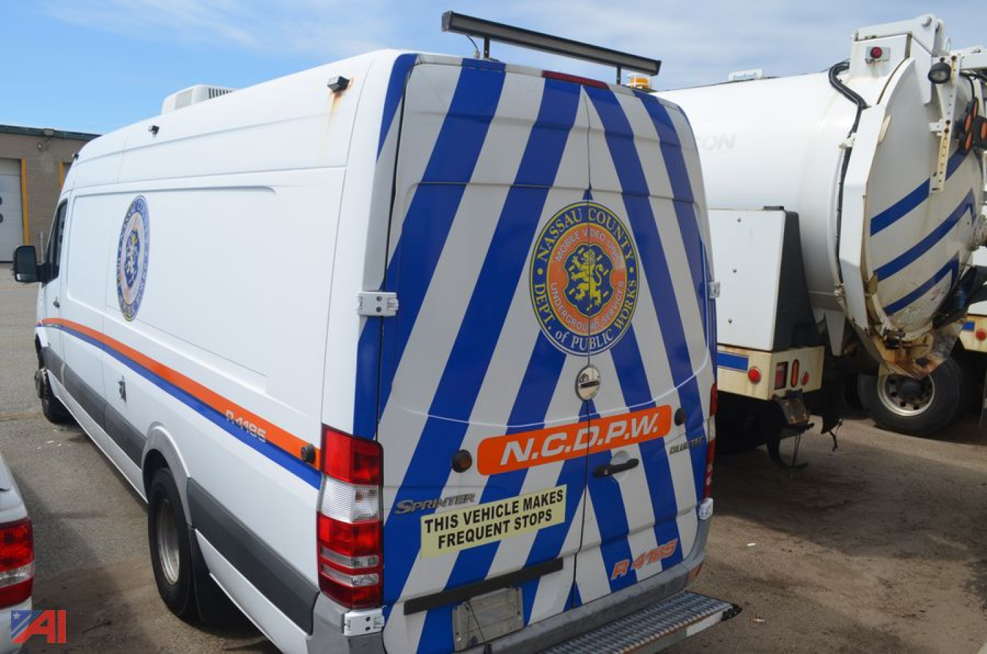 Freightliner Sprinter van rear and side view showing white body with blue diagonal stripes and NCDPW badge on rear door
