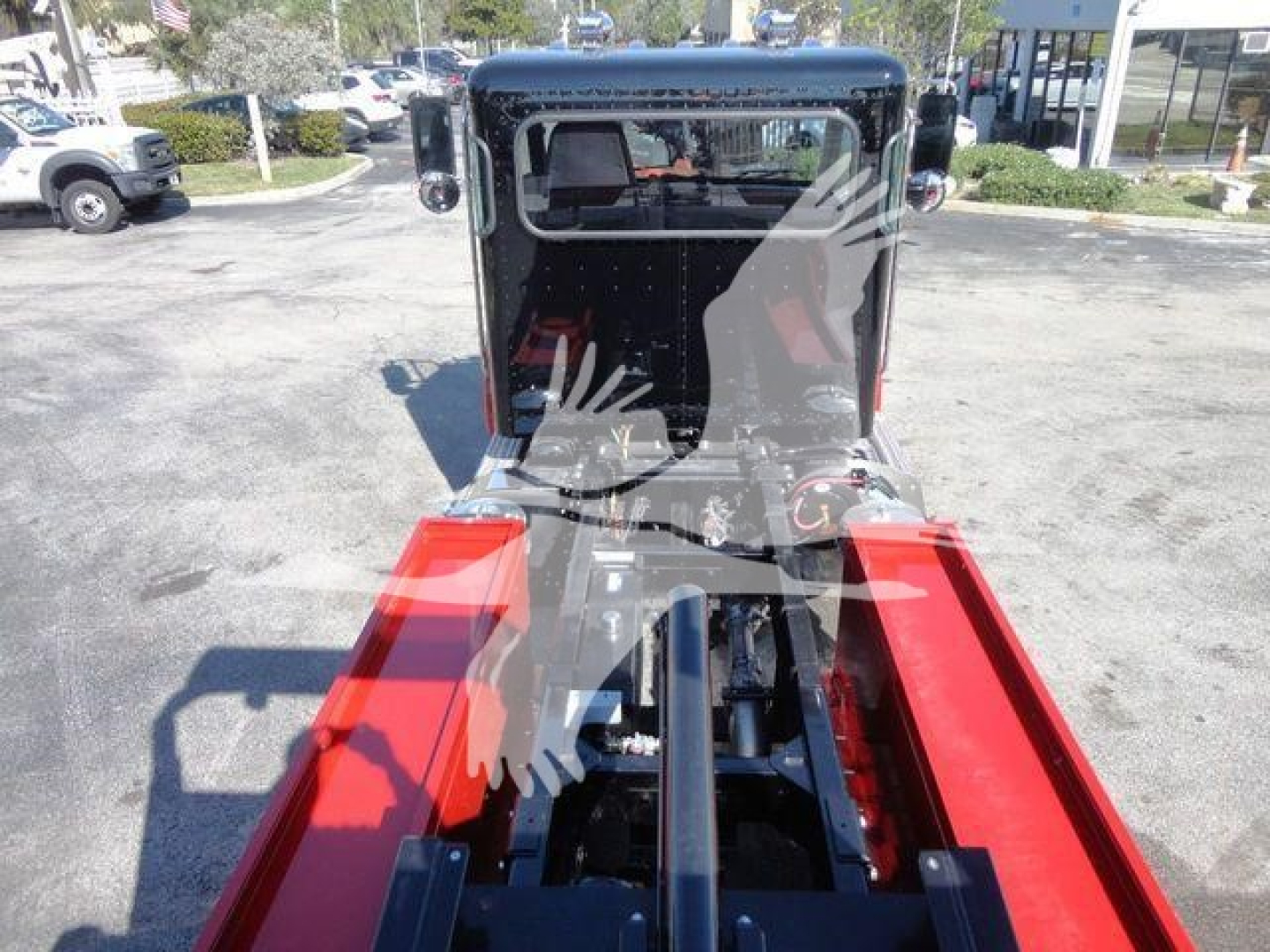 Front view of a 2022 Peterbilt 337 rollback truck showing the chassis rails and cabin area.