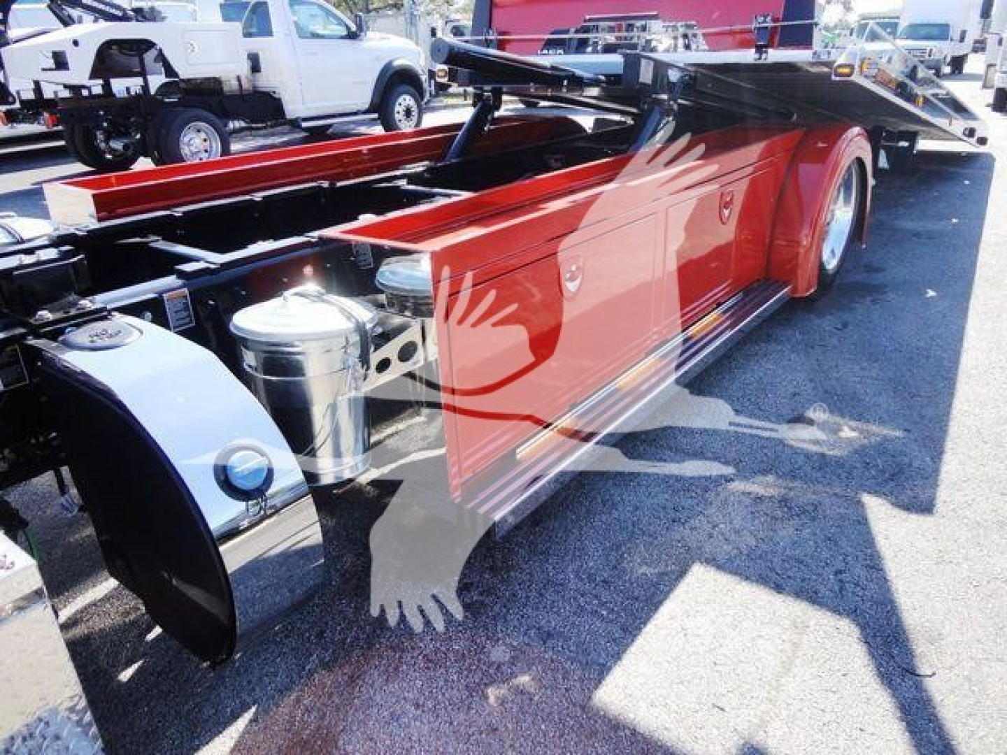 Peterbilt 337 chassis/tandem truck frame with red paint and chrome tanks, side view showing frame rails and components.