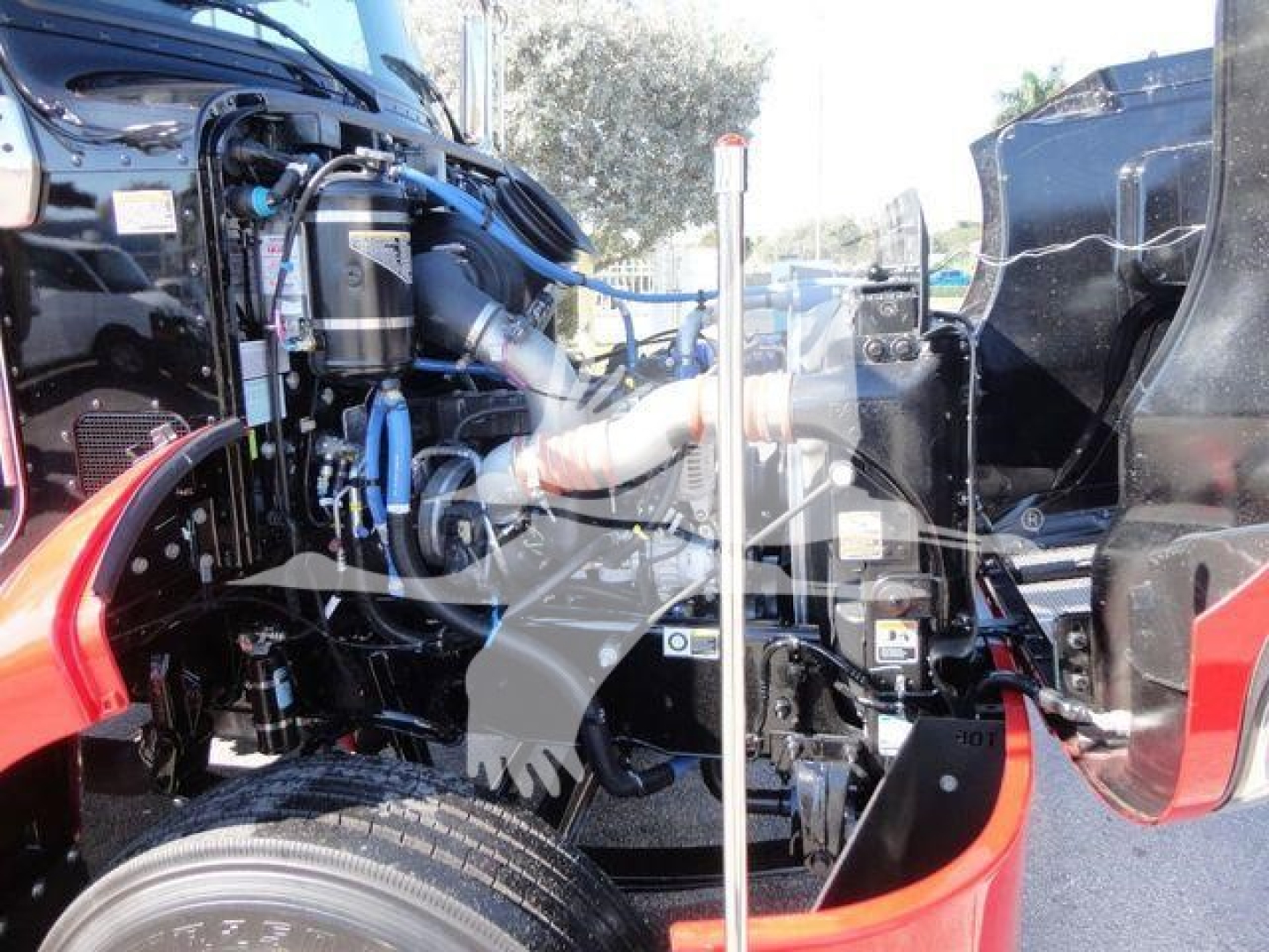  Peterbilt 337 engine bay showing near-side components and wiring with a large black air intake and red accents.