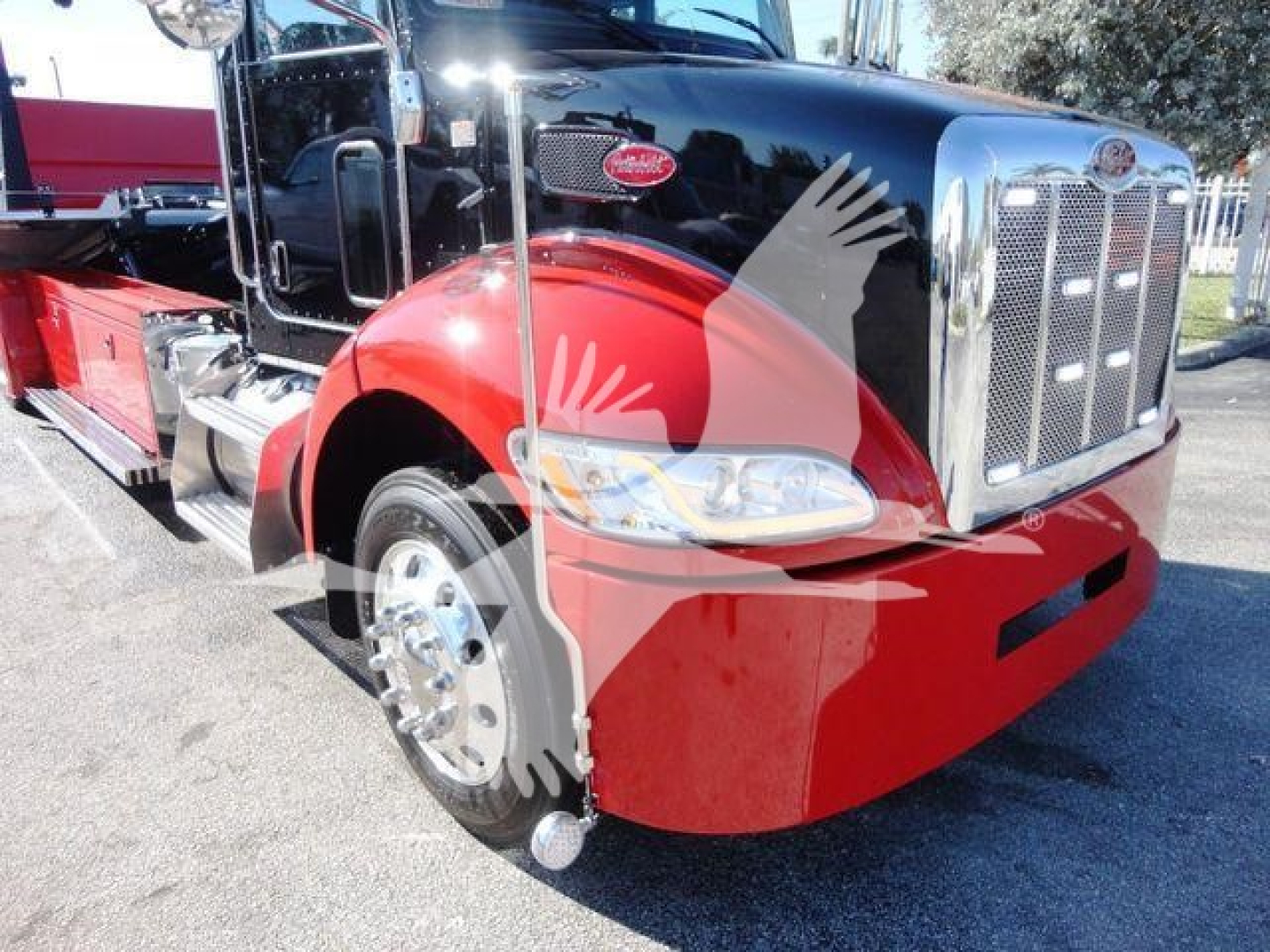 Peterbilt 337 rolled truck front-left view showing red bumper and chrome grille with Peterbilt emblem.