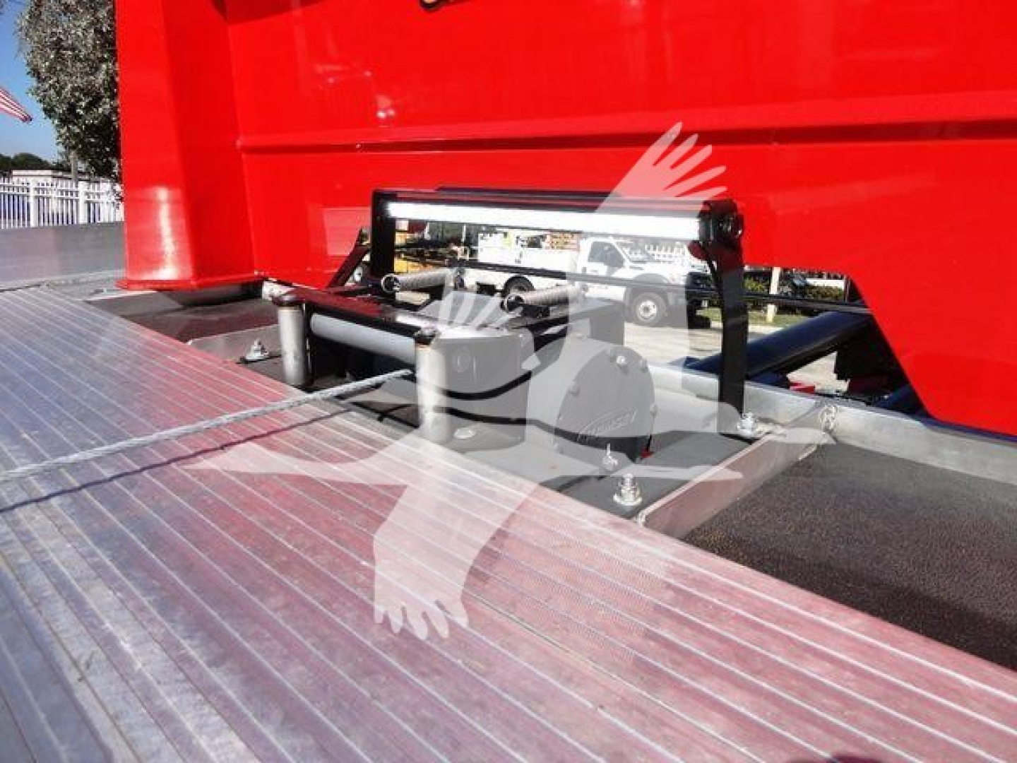 Peterbilt 337 rollback truck bed with hydraulic lift mechanism and chrome step surface.