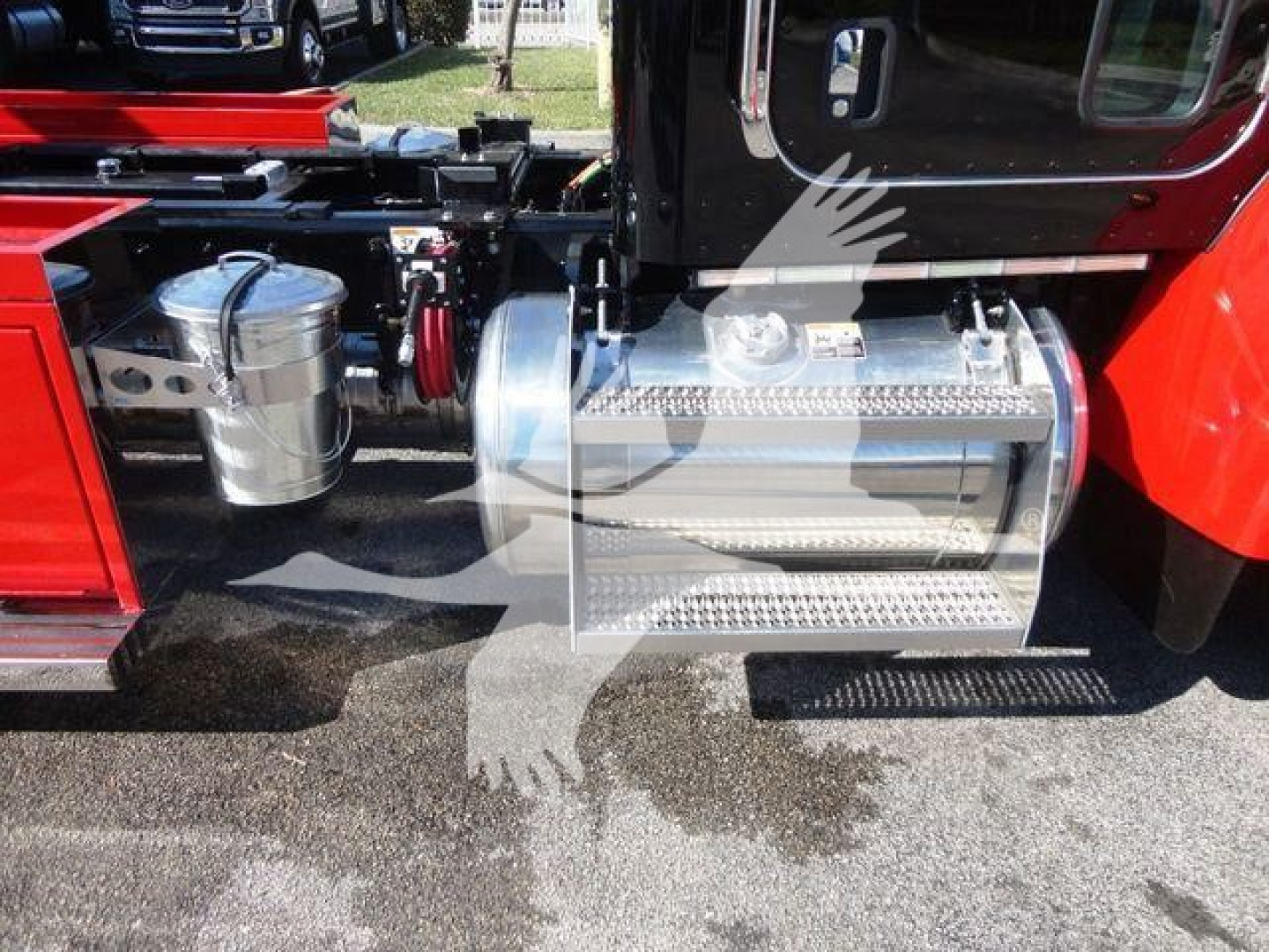 Peterbilt 337 rollback truck side view showing polished aluminum fuel tank/step and chrome fuel lines with surrounding chassis components.