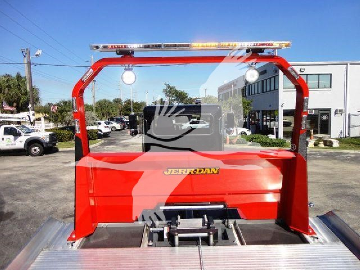 Truck bed of a red Peterbilt 337 rollback shown with a clear rear cab view and equipment mount.