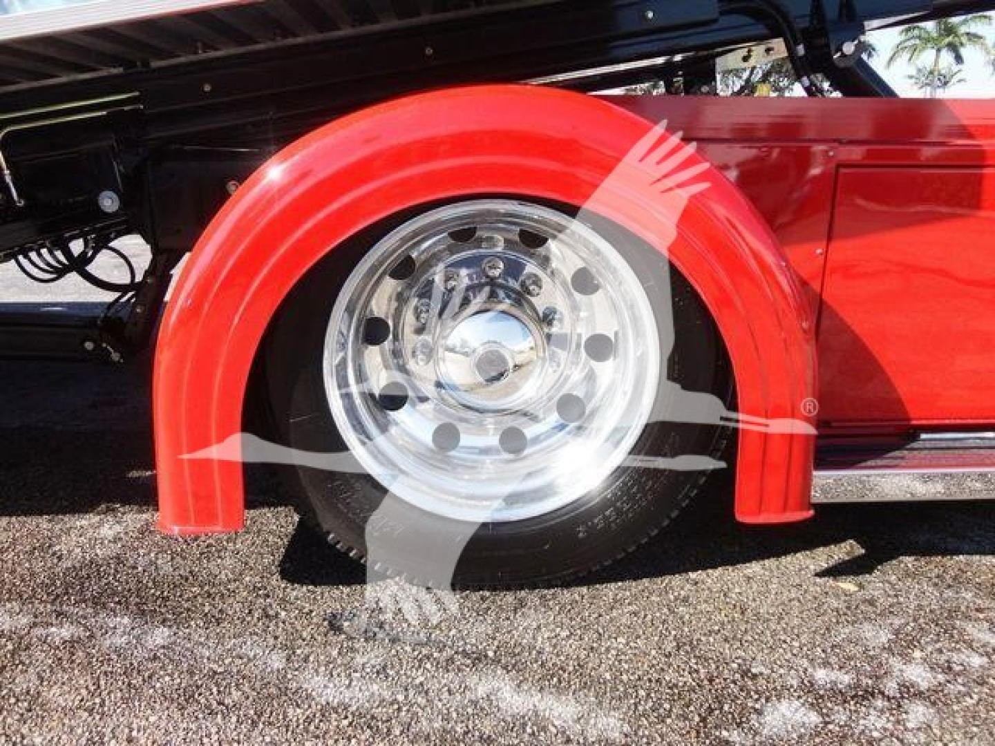 Peterbilt 337 rollback trucks showing front right wheel with red fender and chrome wheel well.