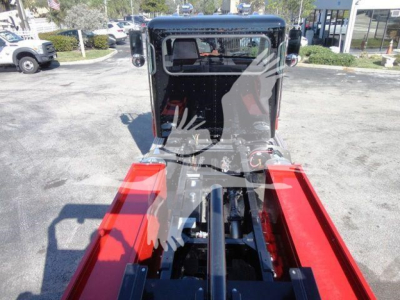 Front view of a 2022 Peterbilt 337 rollback truck showing the chassis rails and cabin area.