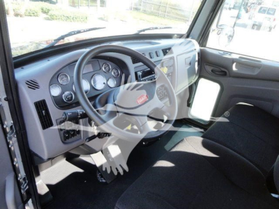 Peterbilt 337 cab interior showing steering wheel dashboard gauges and driver seat.