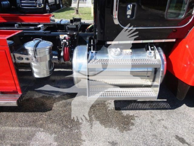 Peterbilt 337 rollback truck side view showing polished aluminum fuel tank/step and chrome fuel lines with surrounding chassis components.