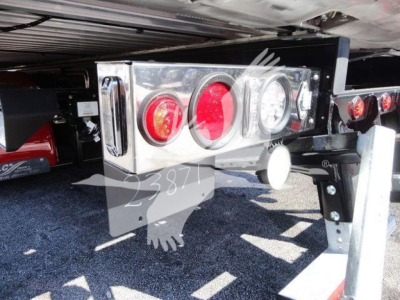Peterbilt 337 rollback rear undercarriage showing chrome taillight assembly with red and white circular lights and bumper supports.