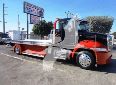2022 Peterbilt 337 rollback truck side view showing a red and black cab with a long aluminum flatbed, front chrome bumper, round mirrors, and large chrome wheels.