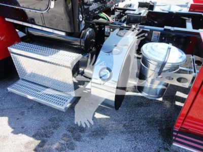 Truck side panel and tool compartments on a Peterbilt 337 rollback; chrome toolbox with diamond plate, exhaust or air filter canister, step rungs, and chassis components visible.