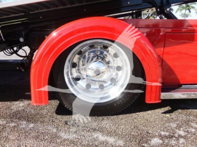 Peterbilt 337 rollback trucks showing front right wheel with red fender and chrome wheel well.