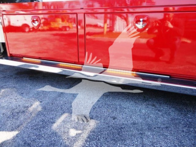 Peterbilt 337 truck side panel reflection and lower door area with red paint and chrome trim.
