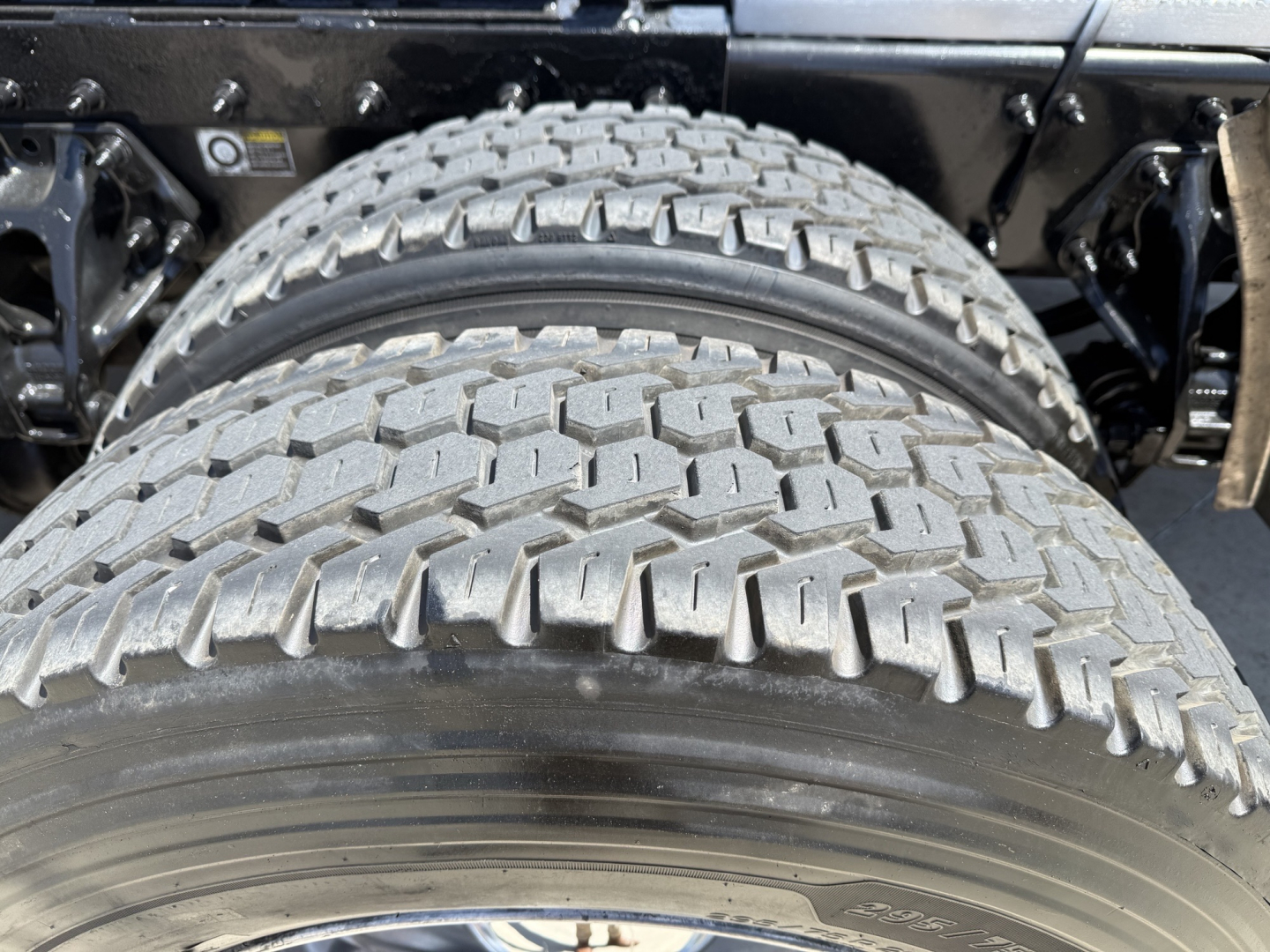 Peterbilt 579 truck dual rear wheels with heavy tread tires and undercarriage view.