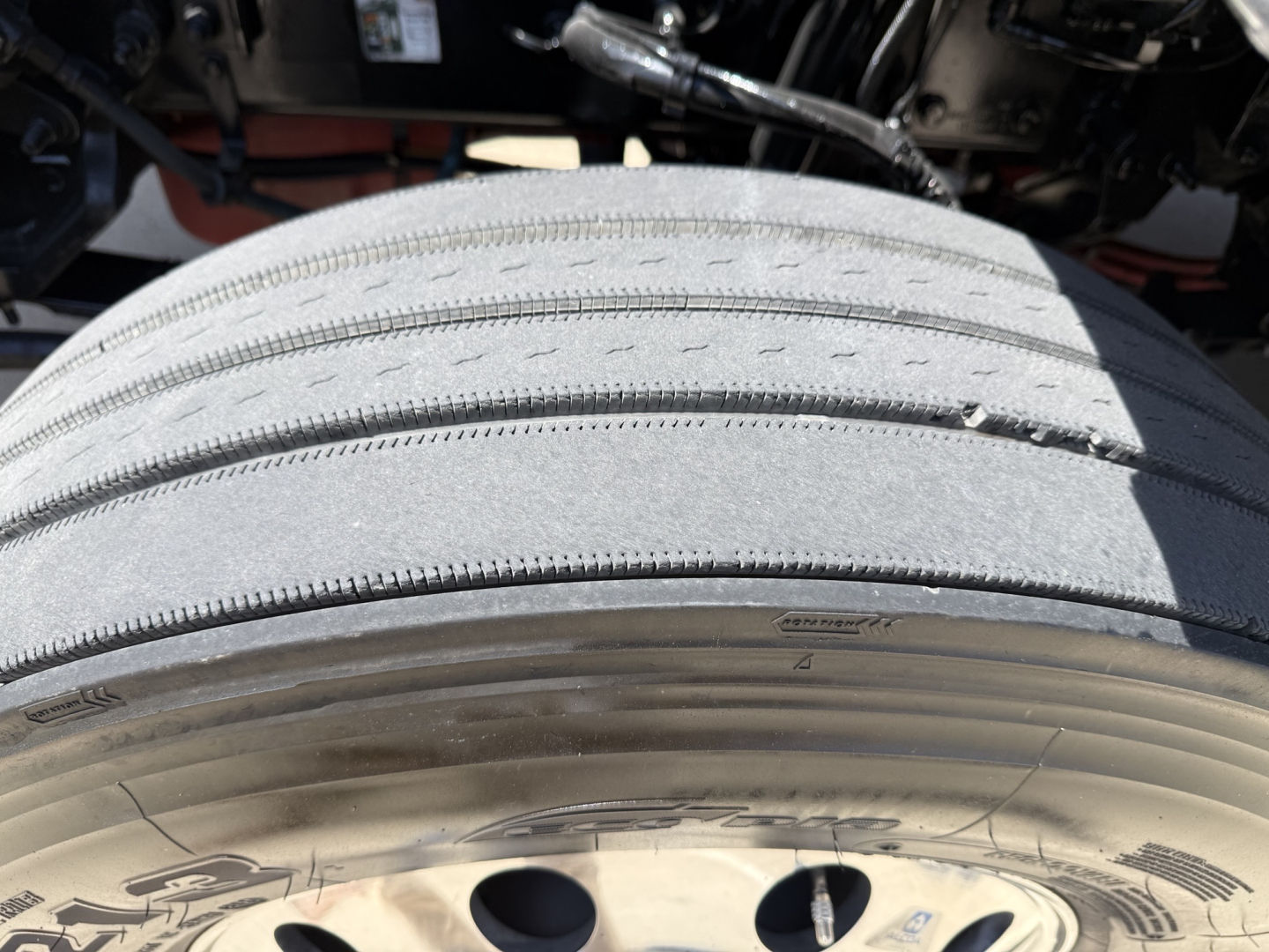 Peterbilt 579 front tire and wheel well as seen from side angle; tread details visible with wheel and undercarriage components