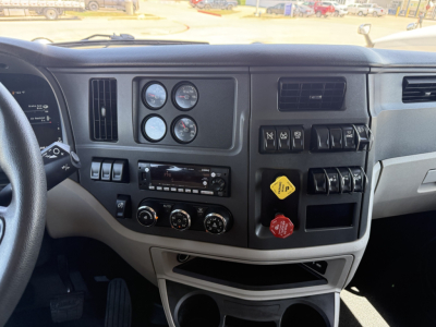 Peterbilt 579 truck dashboard and control panel with gauges, switches, and climate controls visible.