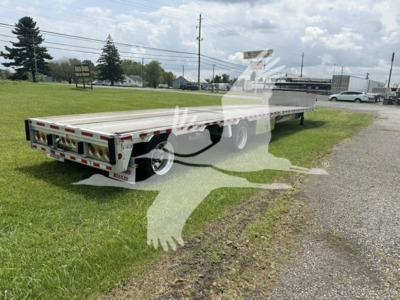 Trailer deck showing 2019 Reitnouer Dropmiser with Ras system, low-angle perspective, aluminum drop deck trailer with multiple axles and rear taillights.