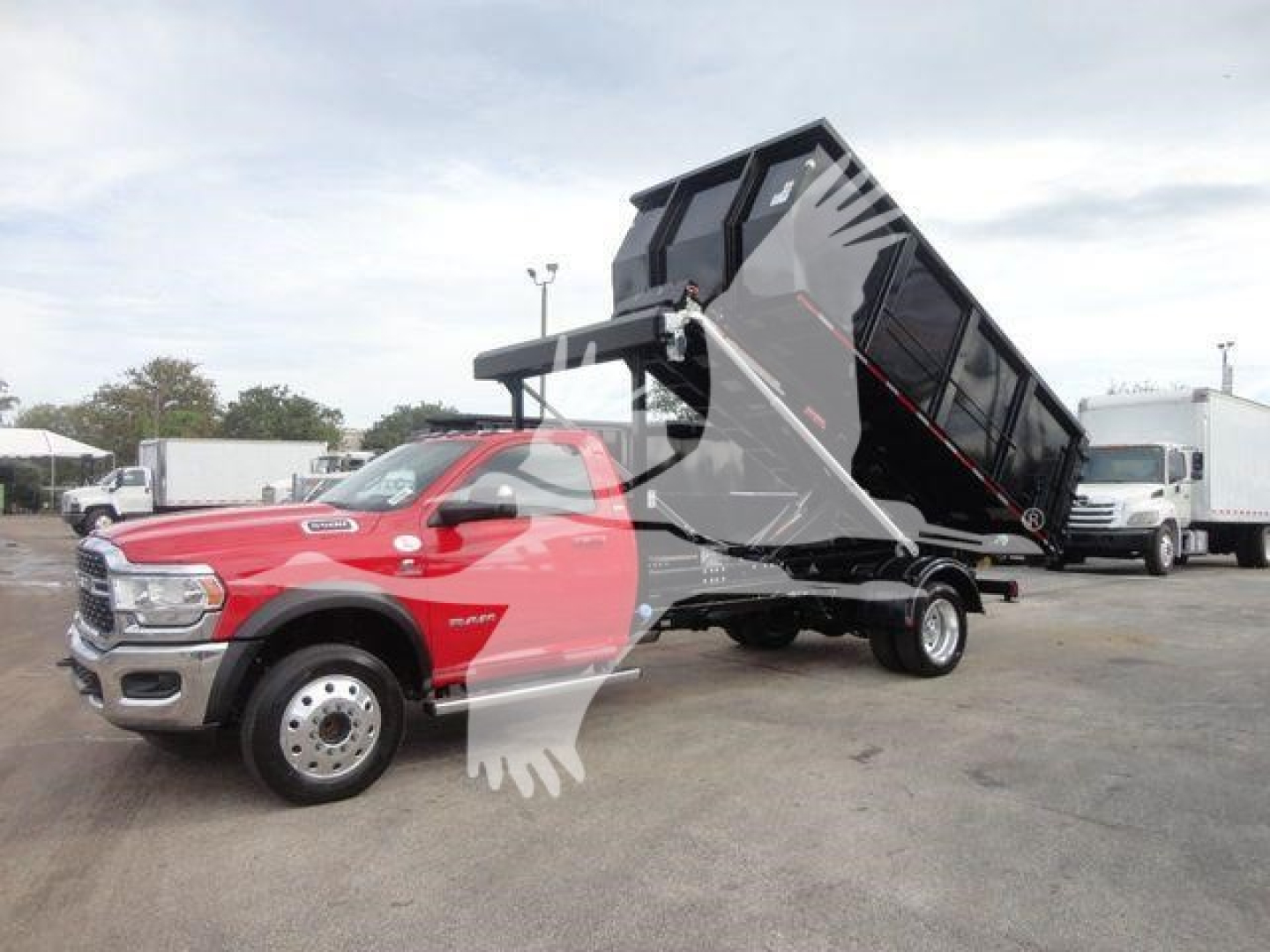 Ram 5500 SLT dump truck in-bed hooklift configuration with black dump bed raised, red cab, stock number DSL550014SNGFM.