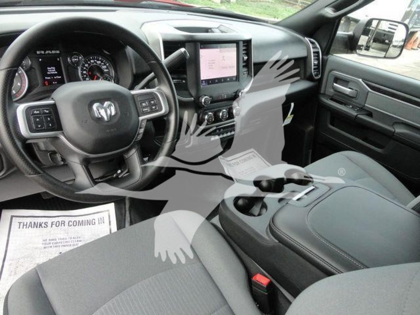 Ram 5500 SLT interior showing steering wheel, dashboard, center touchscreen, and front seats.