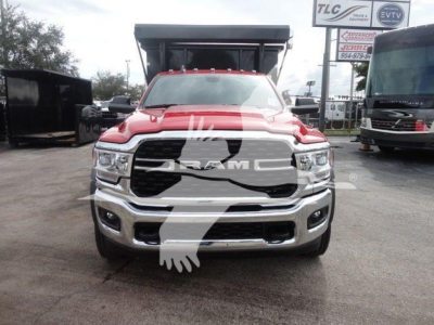 Front view of a red 2024 Ram 5500 SLT pickup truck with large grille and bumper, showing RAM badge and headlights.