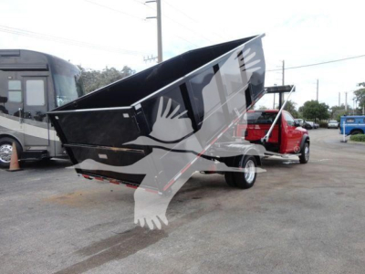 Ram 5500 SLT dump bed truck on a trailer, raised bed with black color