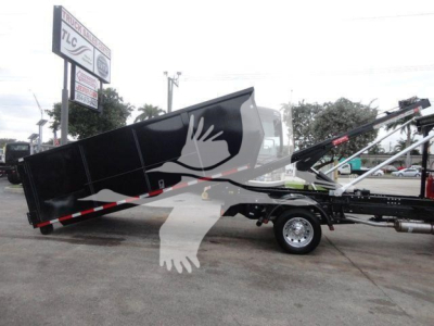 Ram 5500 SLT hooklift truck in-service showing black dump body and hydraulic arms