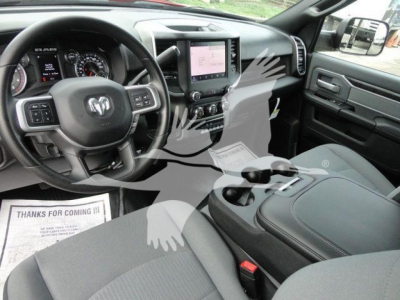 Ram 5500 SLT interior showing steering wheel, dashboard, center touchscreen, and front seats.