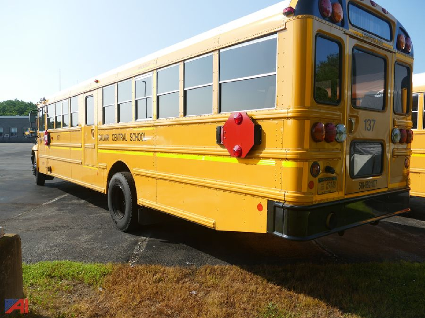 Yellow IC Corporation CE 3000 school bus rear and side view showing windows, rear lights, and school bus markings.