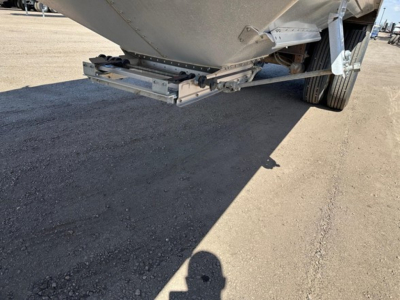 Hopper trailer rear view showing underside and suspension of a Timpte Super Hopper W trailer with metal frame and wheels visible.