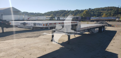 Manac aluminum dropdeck trailer in a road yard showing 172A marking and flatbed surface.