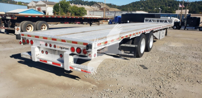Manac aluminum dropdeck trailer side and rear showing load deck, wheels, and rear bumper with taillights; visible brand 'manac' on rear guard.