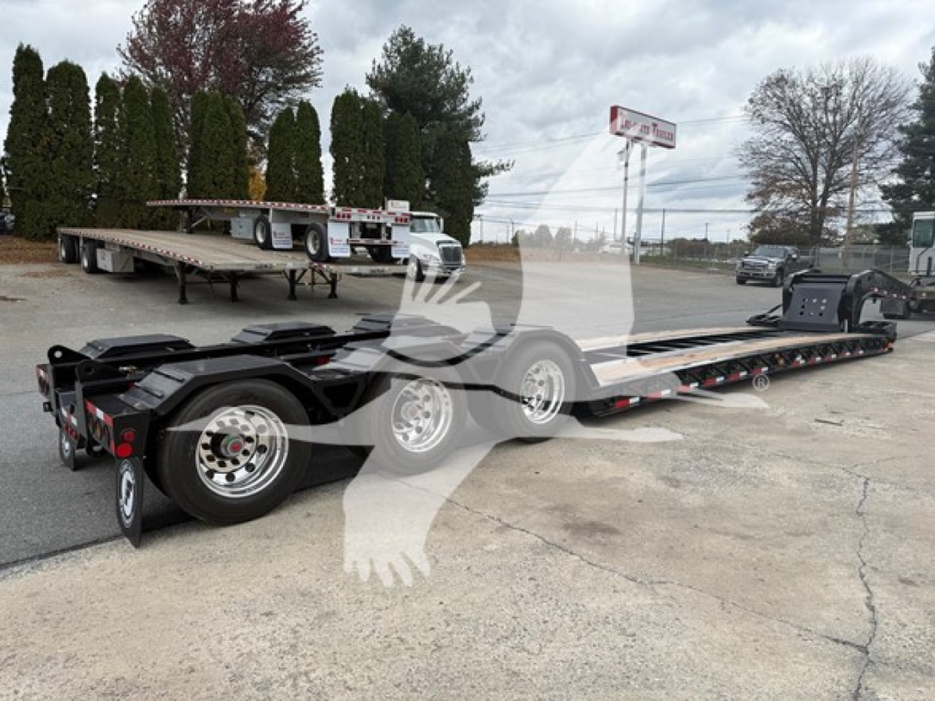 Fontaine Workhorse 55 LCC lowboy trailer showing long flatbed with multiple axles and hydraulic ramps.