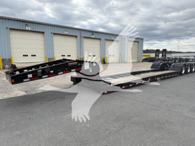  Fontaine Workhorse lowboy trailer in a parking lot with multiple axles and a gooseneck style front, side rails and rear ramp, VIN plate not visible.