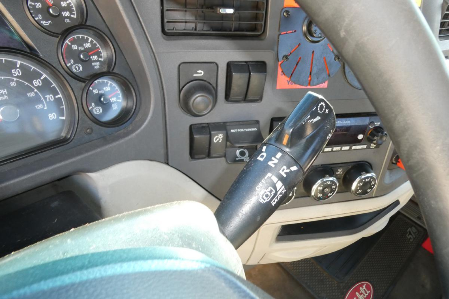 Peterbilt 579 truck interior dashboard and steering column with gear selector stalk and instrument cluster visible